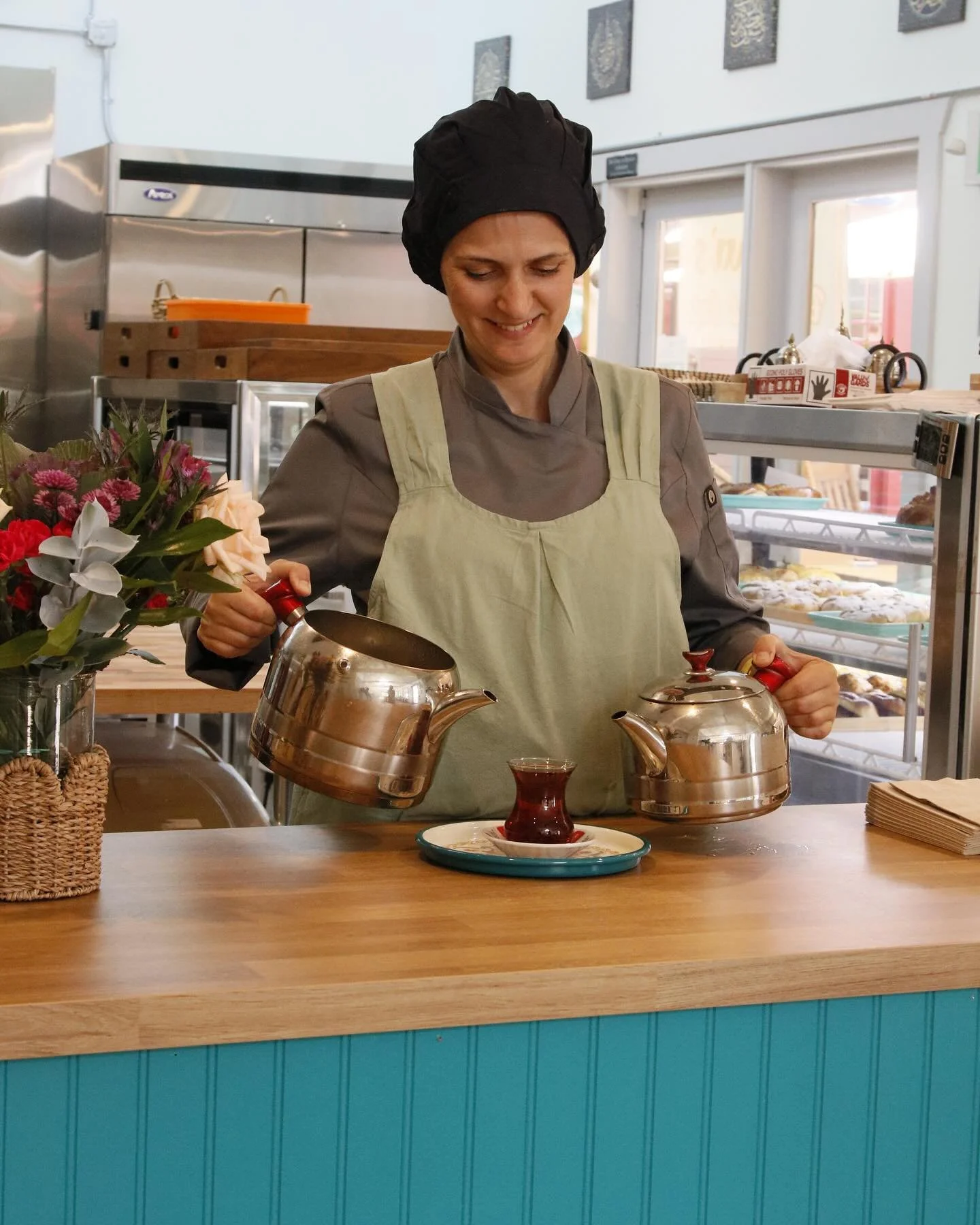 Chef Berna preparing traditional Turkish tea at Berna’s Bakery & Cafe, a women-owned chef-run Turkish breakfast café and local coffee shop in Issaquah.